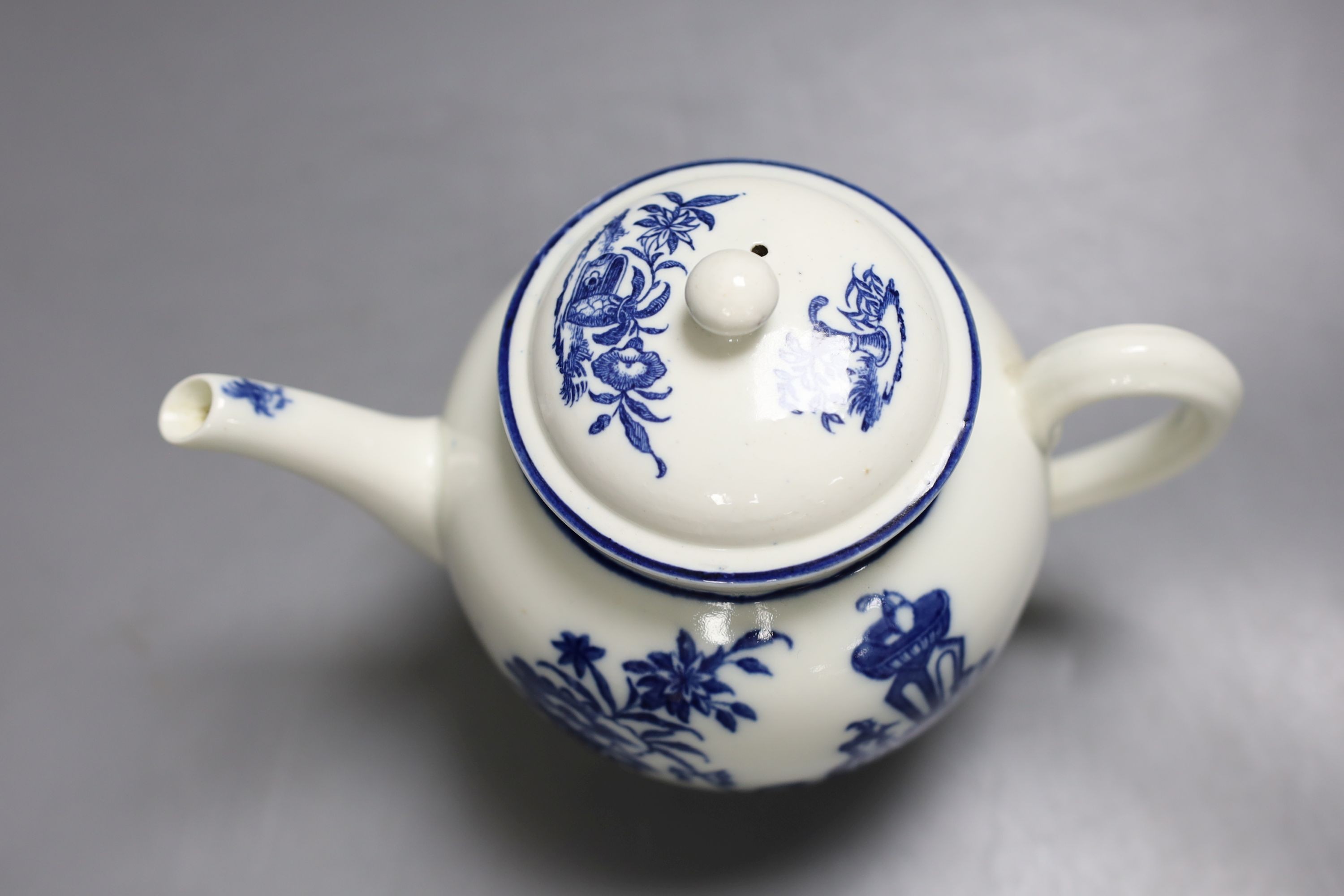 A good Caughley teapot and cover unusually having the same Bell Toy pattern on each side, c.1785, 14.5 cm high